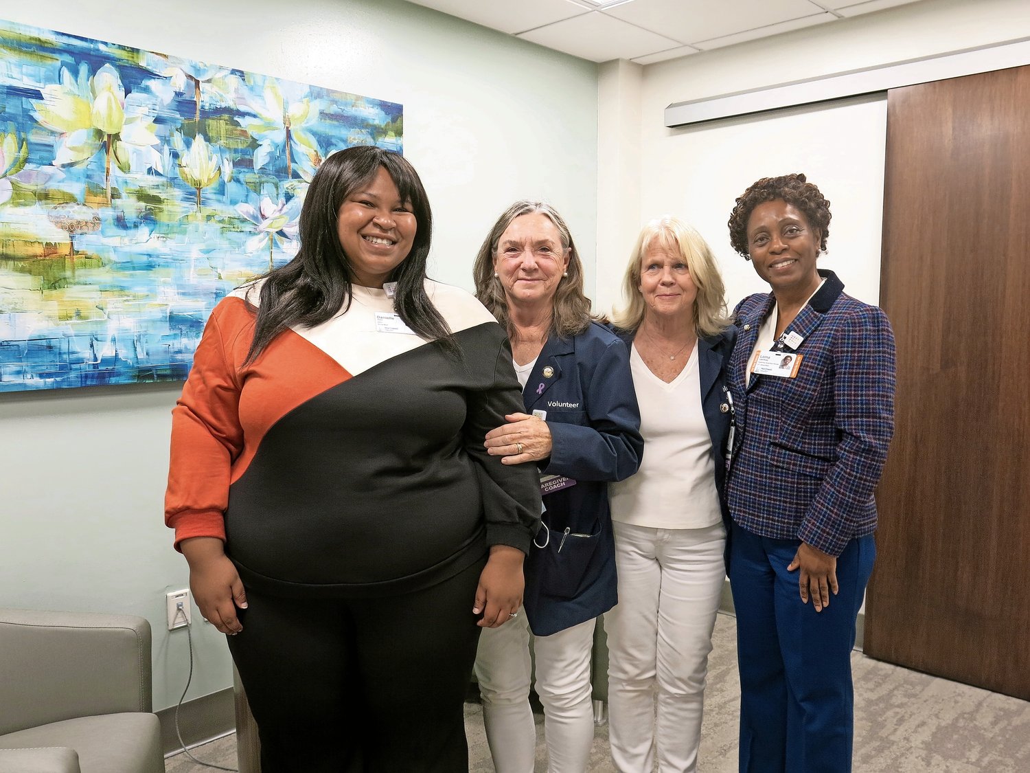 Danielle Kerr, a social work intern from Adelphi, far left, volunteer caregiver coaches Christine Mills and Nancy White, and Lorna Lee-Riley, Glen Cove Hospital’s senior social worker, in one of the rooms at the new Caregiver Center.